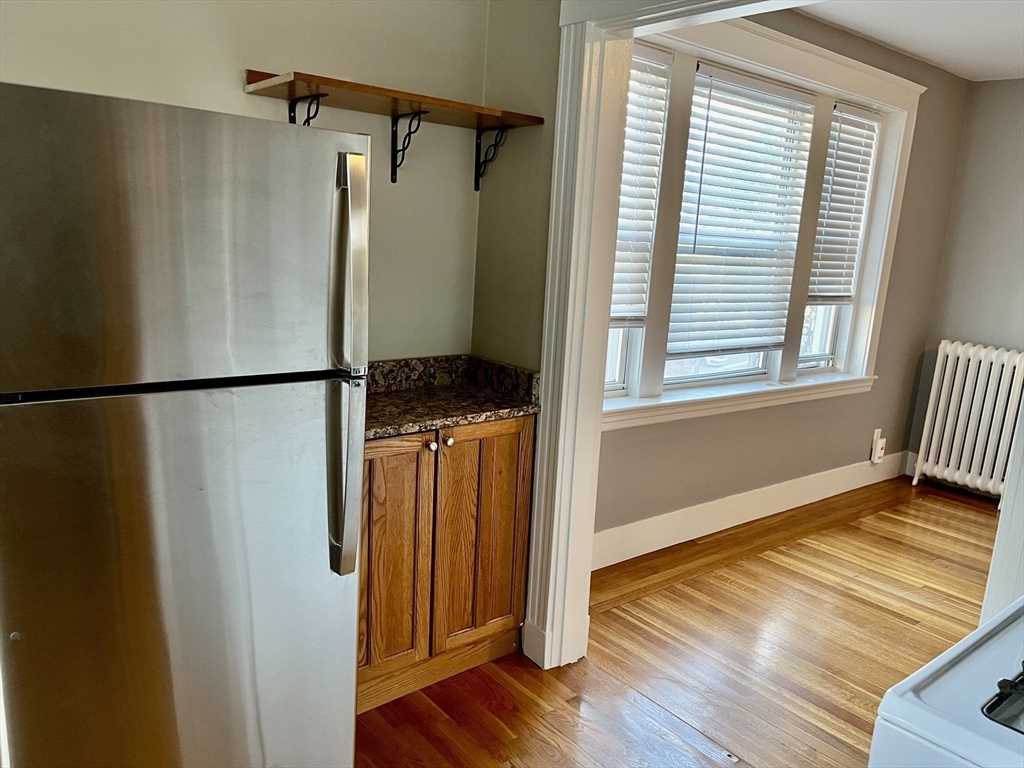 1607 Commonwealth Avenue, Unit 14 Boston, MA 02135 - Photo 5 of 11 a view of a room with wooden floor and a window
