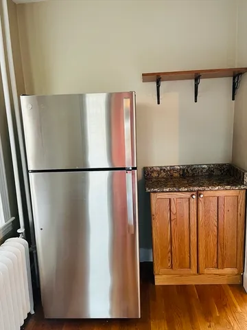 a view of a refrigerator in a kitchen