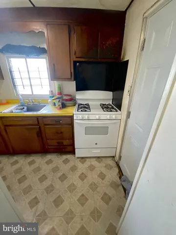 a view of washer and dryer with kitchen in the background