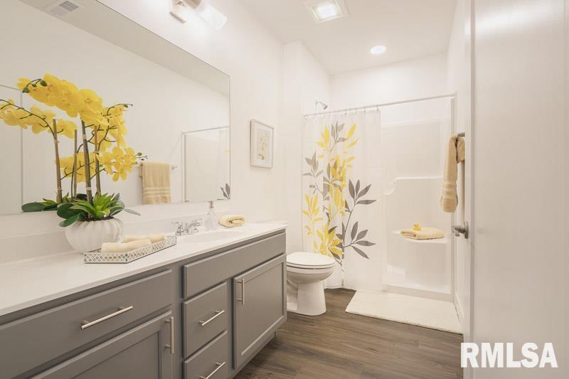 801 Bend Boulevard East Moline, IL 61244 - Photo 3 of 4 a bathroom with a granite countertop sink toilet and shower