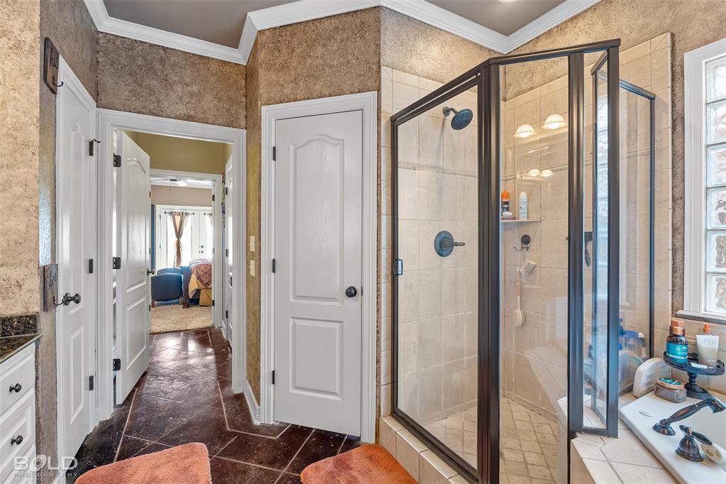 10040 Loveland Court Shreveport, LA 71106 - Photo 17 of 26 a bathroom with a glass shower door and a glass door shower