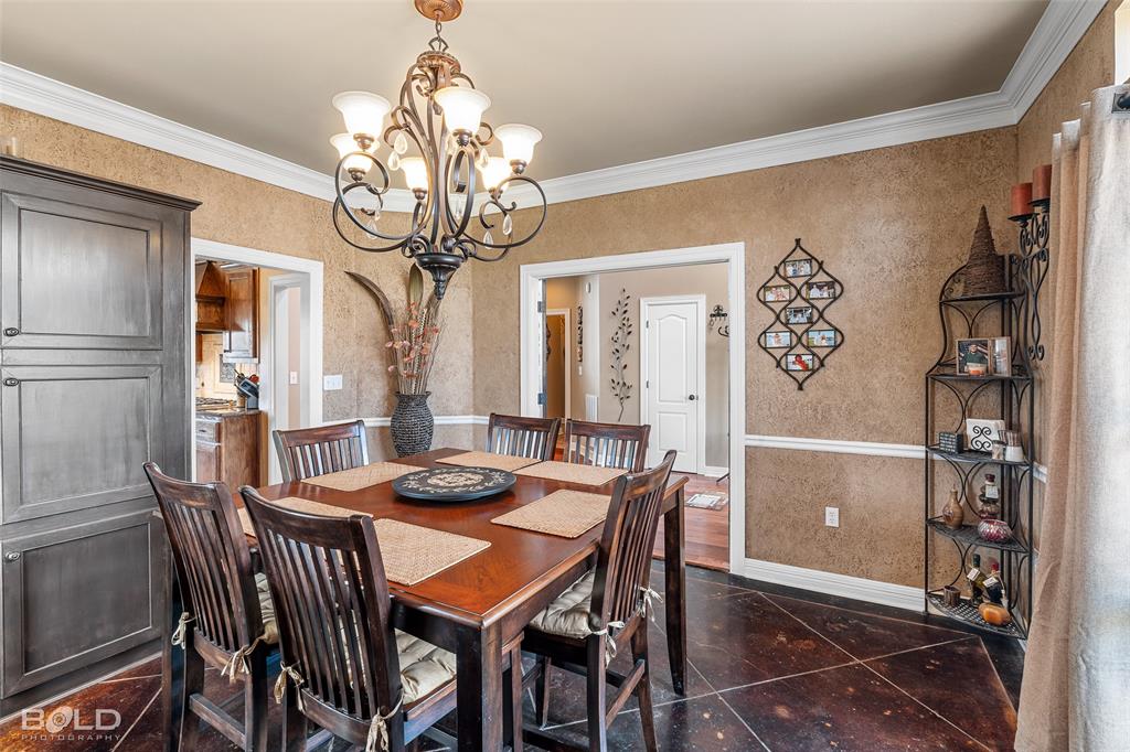 10040 Loveland Court Shreveport, LA 71106 - Photo 7 of 26 a view of a dining room with furniture wooden floor and chandelier