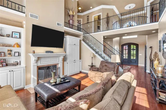 a living room with furniture fireplace and a large window
