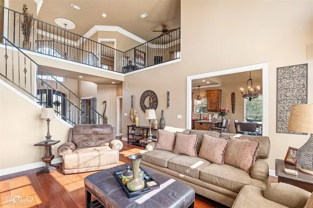 a dining hall with stainless steel appliances granite countertop a refrigerator dining table and chairs