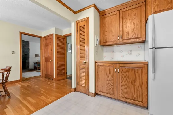 a view of a bedroom with wooden floor and cabinet
