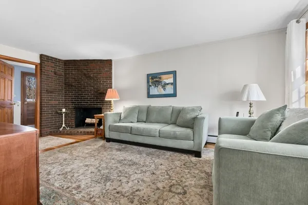 a living room with furniture window and a fireplace