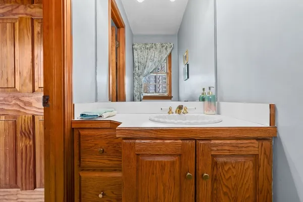 a bathroom with a granite countertop sink and a mirror