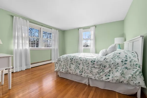a bedroom with a large bed and a window