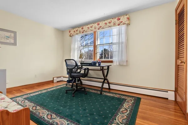 a living room with furniture rug and a window