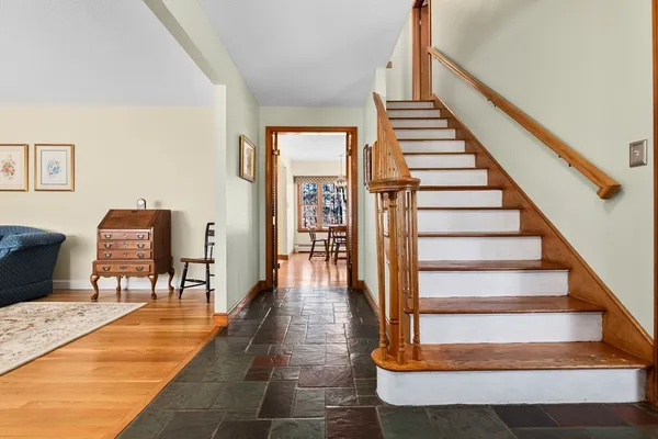 a view of entryway and hall with wooden floor
