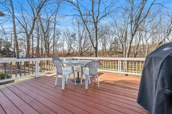 a view of a chairs on deck with wooden floor and fence