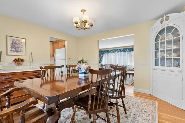 a view of a dining room with furniture and chandelier