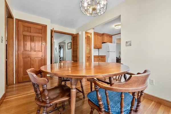 a dining room with furniture and wooden floor