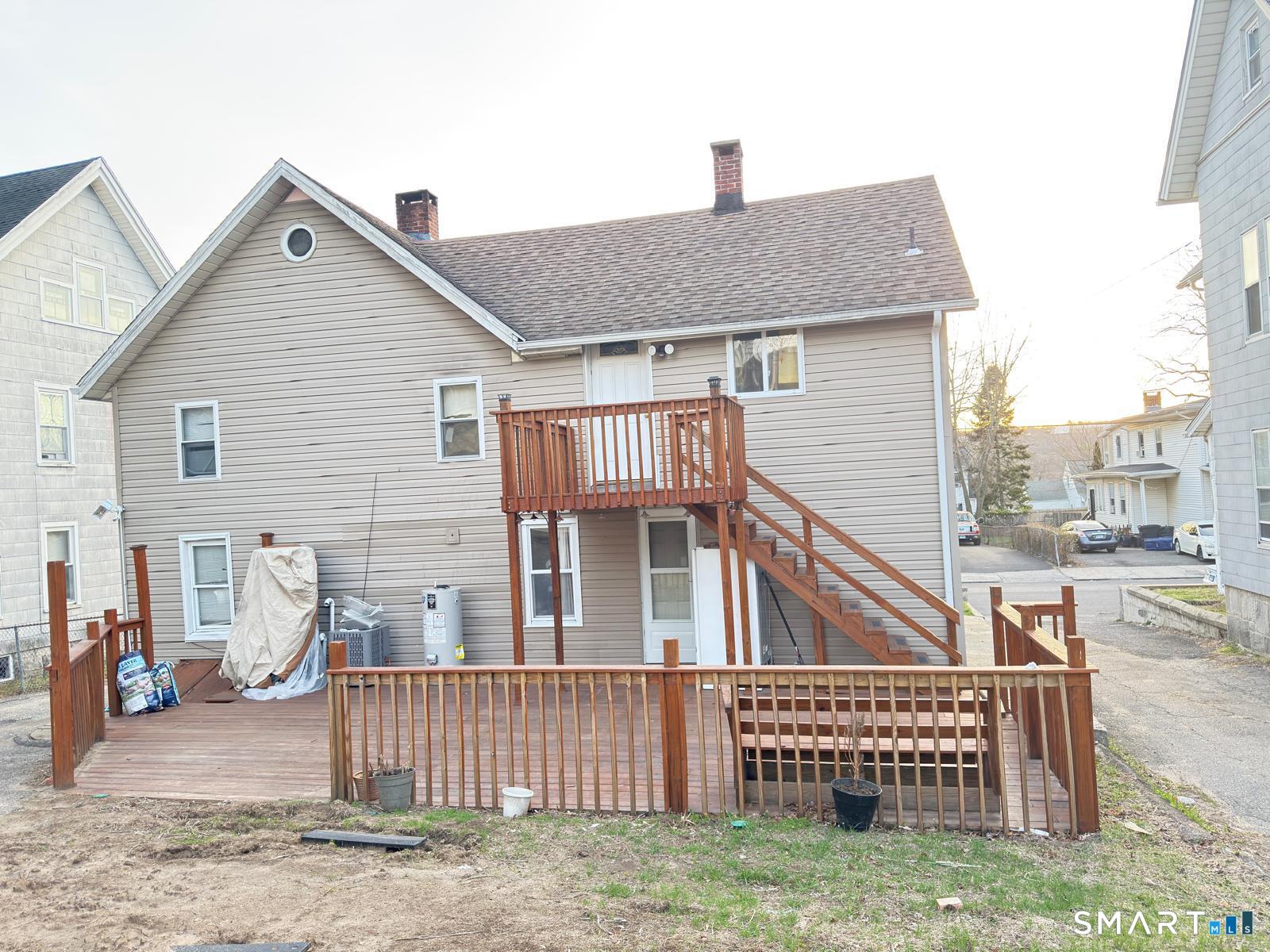 32 Winter Street Ansonia, CT 06401 - Photo 2 of 14 a view of a house with a yard and wooden fence
