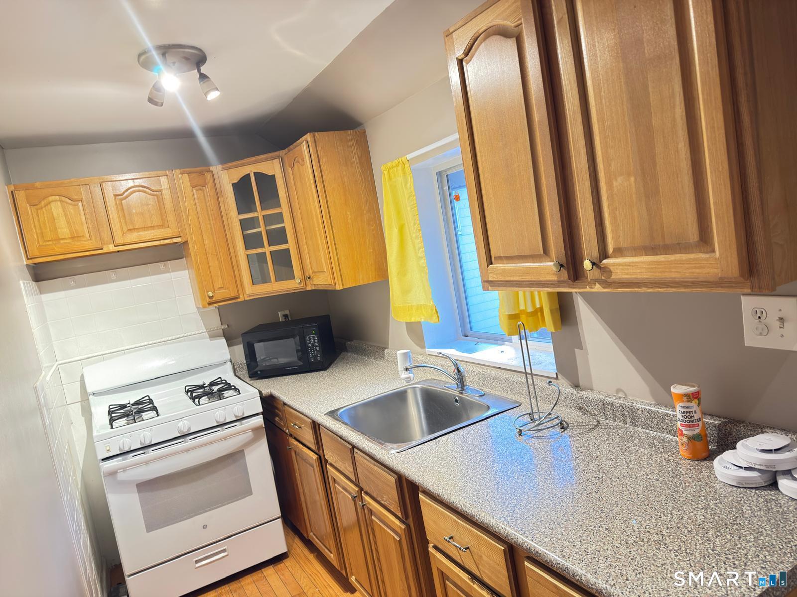 32 Winter Street Ansonia, CT 06401 - Photo 6 of 14 a kitchen with a sink a stove and cabinets