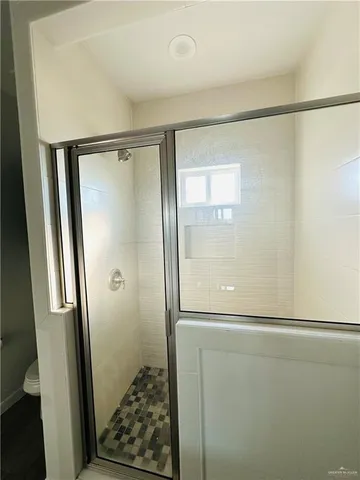 a bathroom with a glass shower door