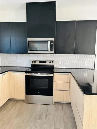 a kitchen with a cabinets and steel appliances