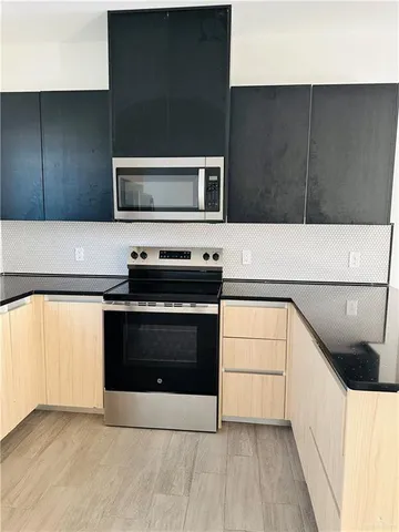 a kitchen with a cabinets and steel appliances