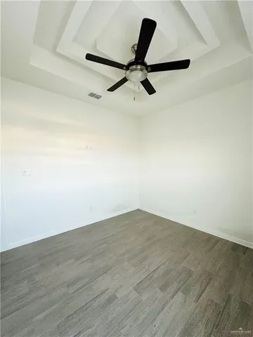 a view of a room with wooden floor