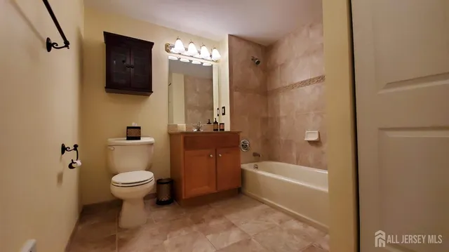 a bathroom with a toilet a sink and bathtub