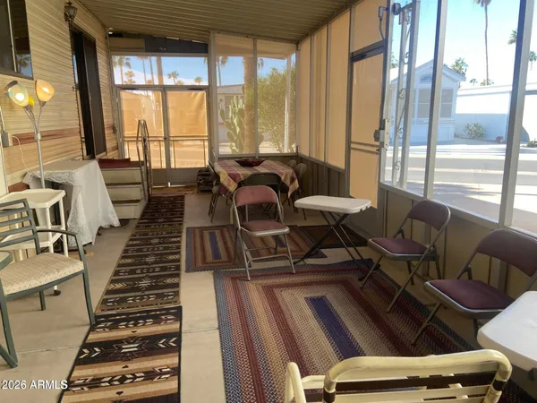 a living room with furniture and a floor to ceiling window