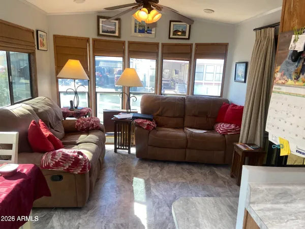 a living room with furniture a window and a chandelier