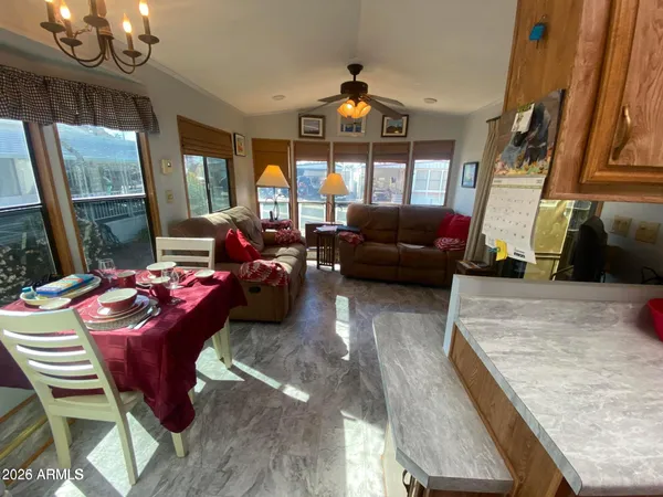 a living room with furniture a fireplace and a chandelier