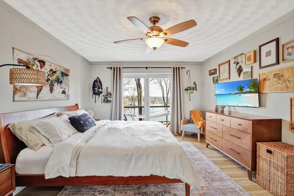a bedroom with a bed and a chandelier