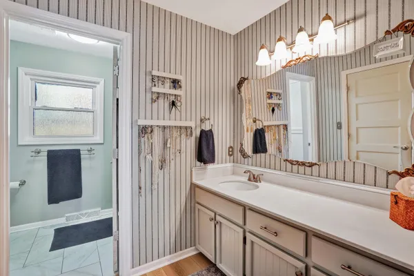 a bedroom with a large bed and a window