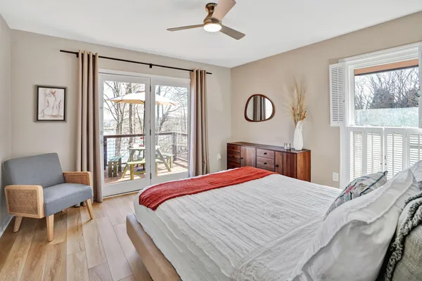 a bedroom with a bed and painting on the wall