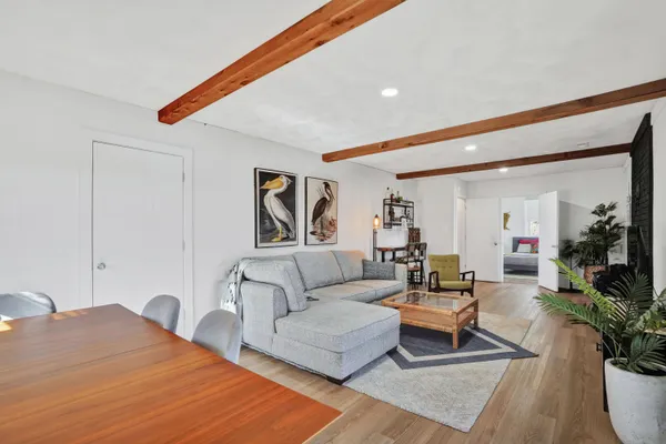 a living room with furniture and large windows