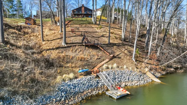 a view of swimming pool with outdoor seating and lake view