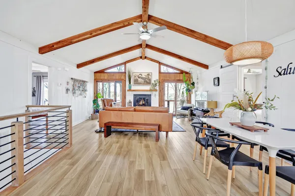 a living room with furniture a rug and a floor to ceiling window