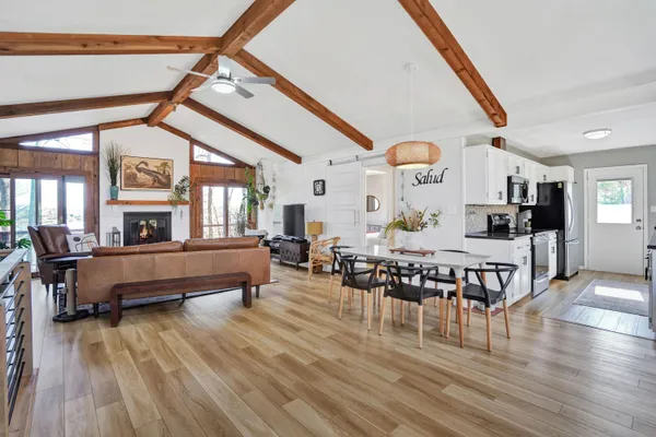 a living room with furniture a fireplace and a large window