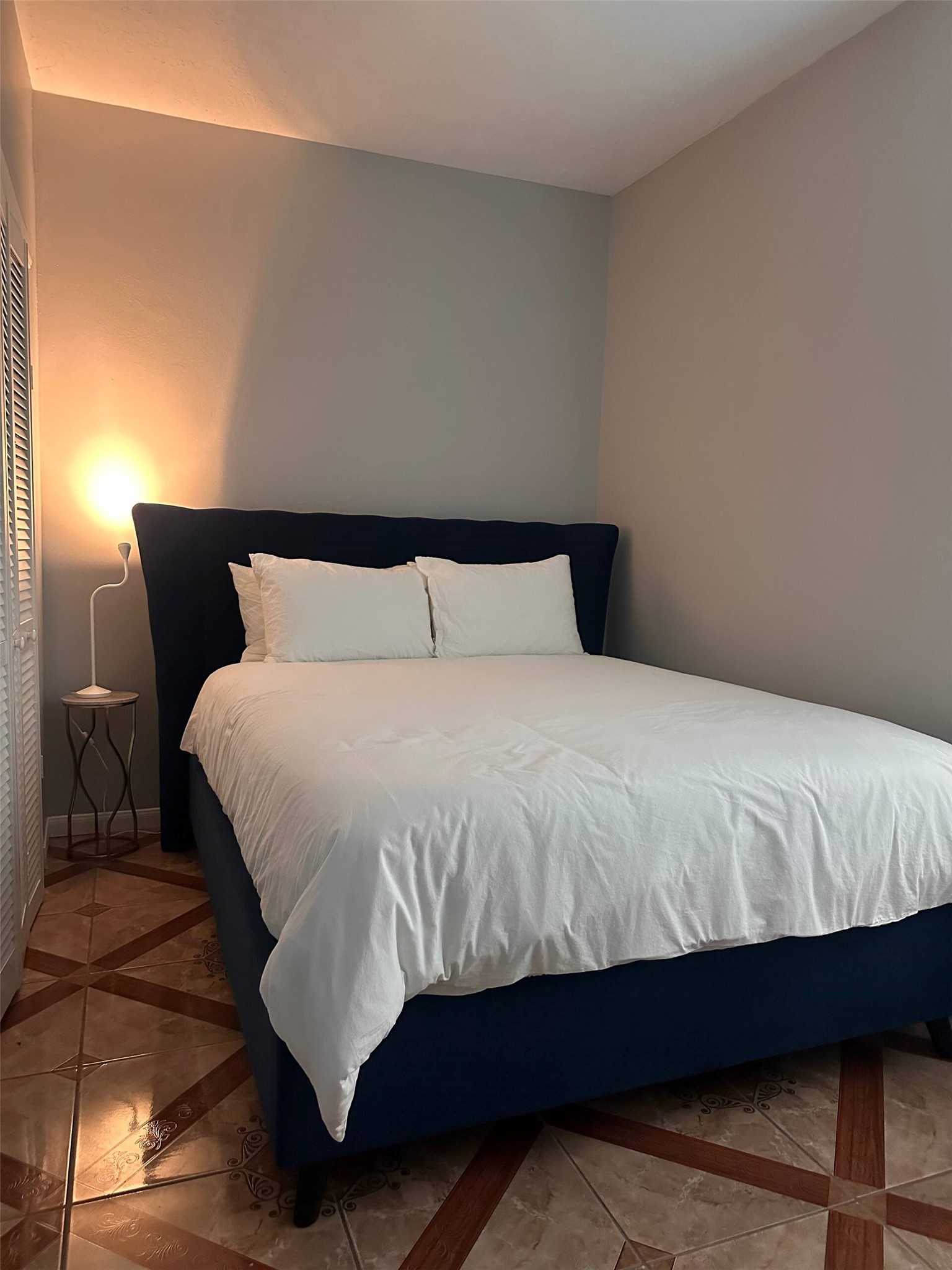 15 Stiles Street Houston, TX 77011 - Photo 14 of 33 a bedroom with a bed and wooden floor