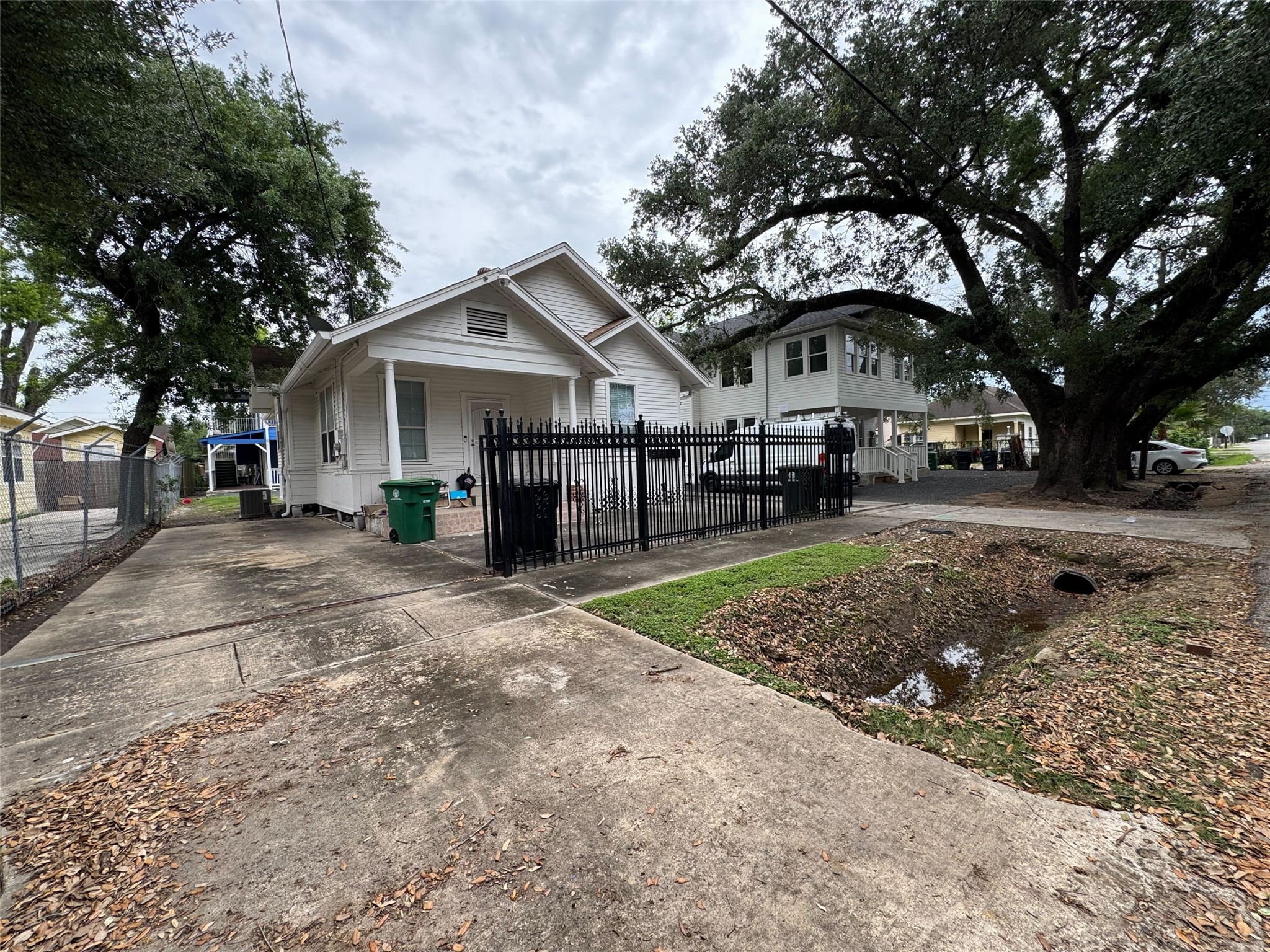 15 Stiles Street Houston, TX 77011 - Photo 2 of 33 a view of a white house next to a yard with big trees