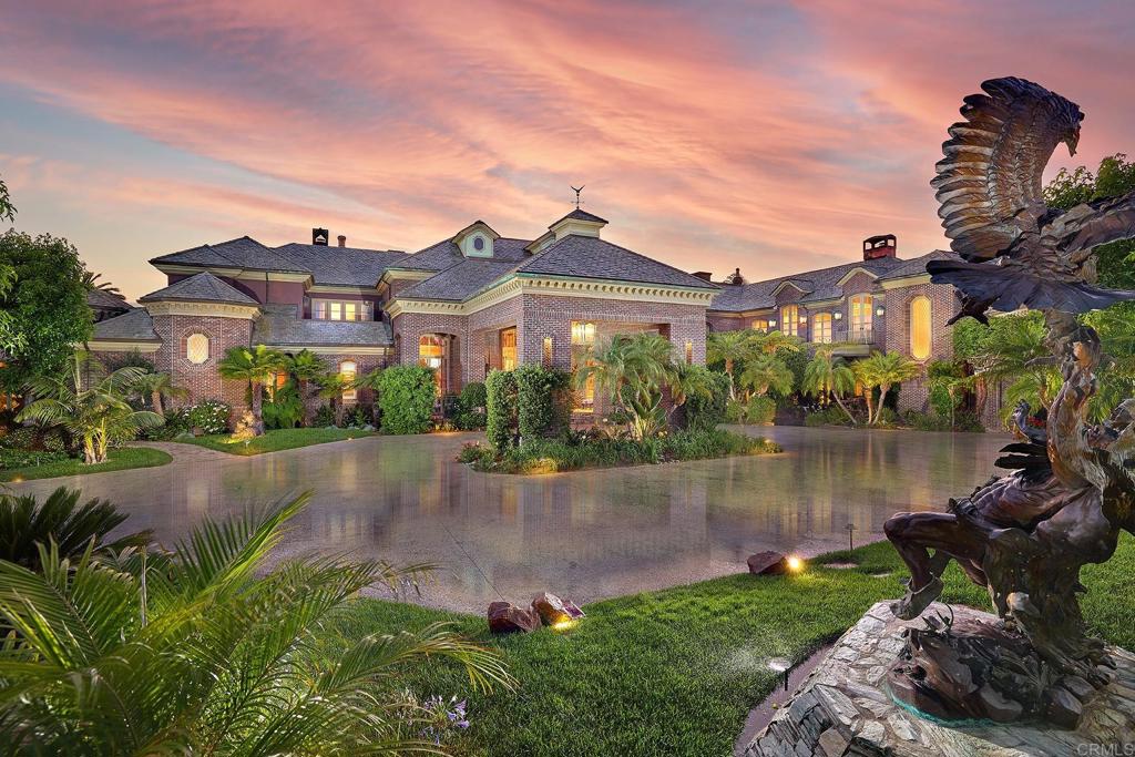 5893 Winland Hills Drive Rancho Santa Fe, CA 92067 - Photo 1 of 40 a view of a lake with a garden in front of it