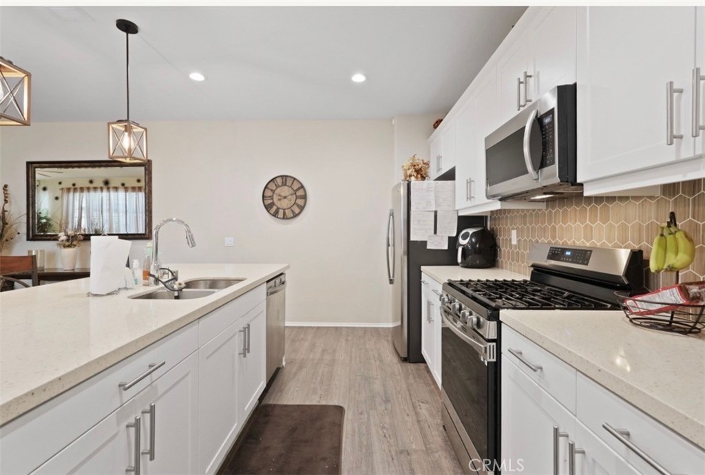 2248 Ridge Court Perris, CA 92571 - Photo 12 of 48 a kitchen with stainless steel appliances a sink stove and microwave