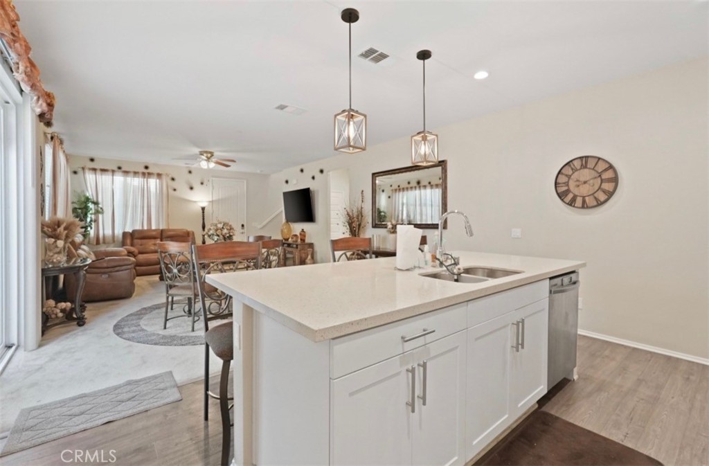 2248 Ridge Court Perris, CA 92571 - Photo 13 of 48 a kitchen with a sink a stove and a clock on the wall