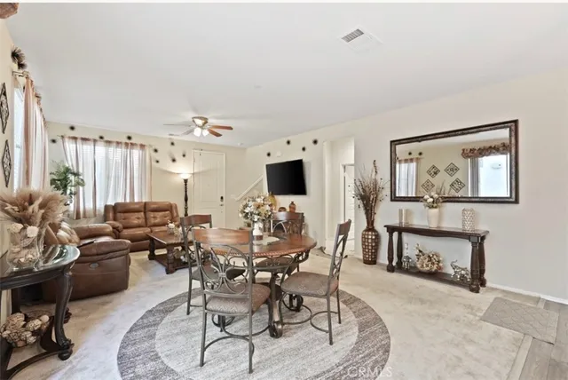 a dining room with furniture and view kitchen