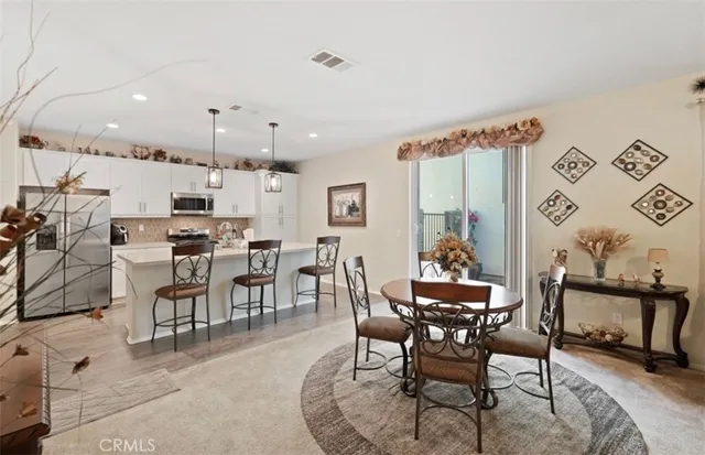 a view of a dining room with furniture and a potted plant