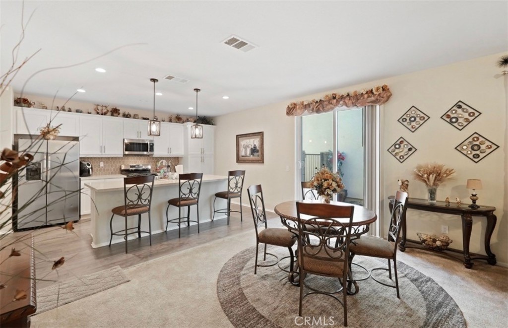 2248 Ridge Court Perris, CA 92571 - Photo 16 of 48 a dining room with furniture and view kitchen