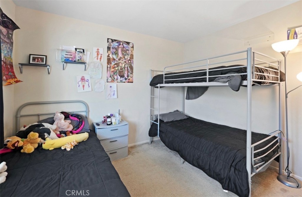 2248 Ridge Court Perris, CA 92571 - Photo 22 of 48 a bedroom with a bed and cabinets