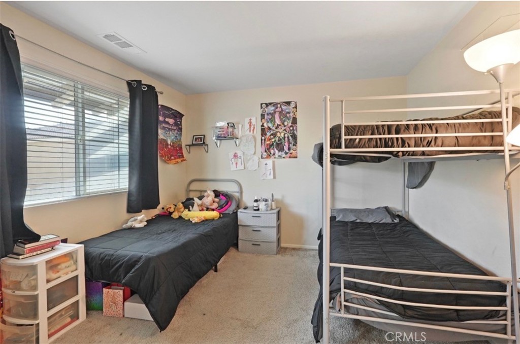 2248 Ridge Court Perris, CA 92571 - Photo 23 of 48 a bedroom with furniture and a window