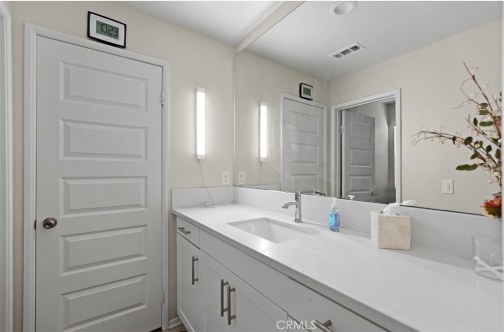 2248 Ridge Court Perris, CA 92571 - Photo 25 of 48 a bathroom with a sink and a mirror