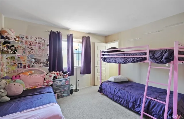 a bedroom with bed and a window