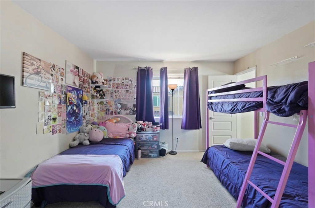 2248 Ridge Court Perris, CA 92571 - Photo 30 of 48 a bedroom with bed and a couch