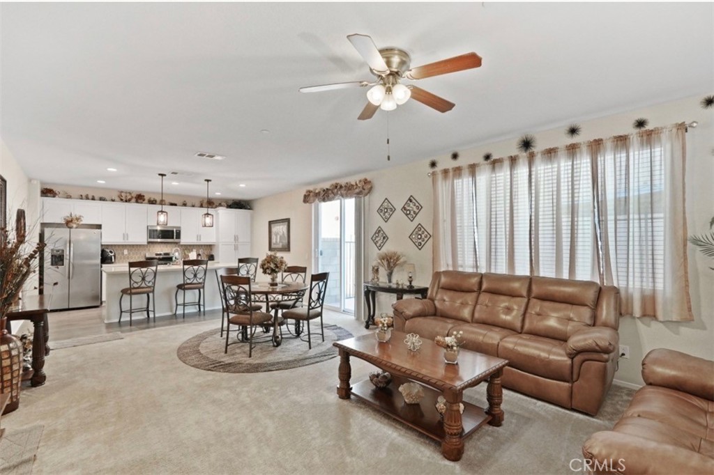 2248 Ridge Court Perris, CA 92571 - Photo 3 of 48 a living room with furniture kitchen view and a chandelier