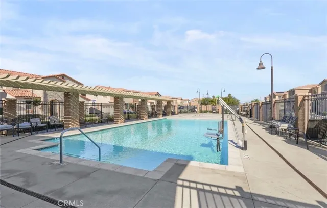 a view of a swimming pool with furniture