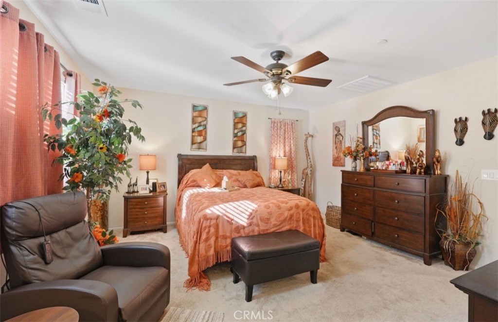 2248 Ridge Court Perris, CA 92571 - Photo 6 of 48 a bedroom with a bed and a chandelier